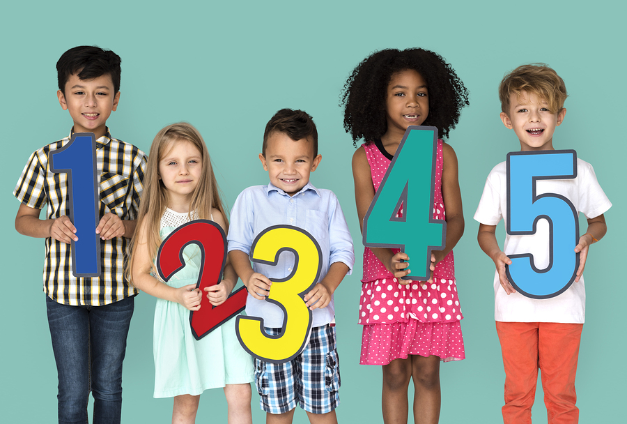 Kids holding cutout paper numbers